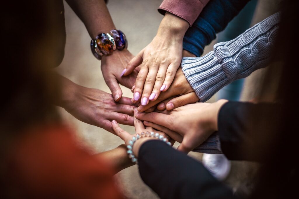 Hands connecting in circle.