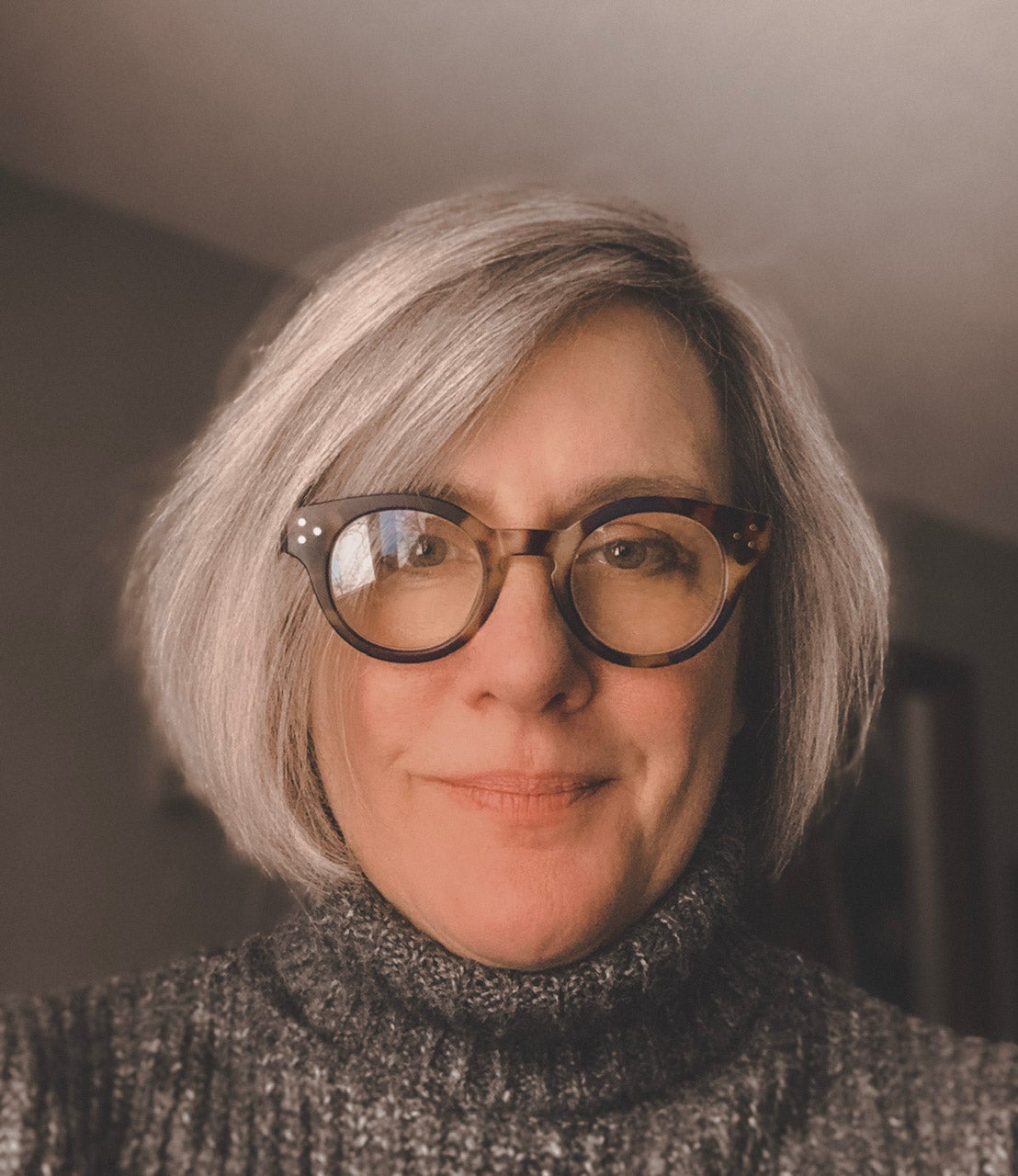 headshot of Rachel who has a bob haircut and wears glassess