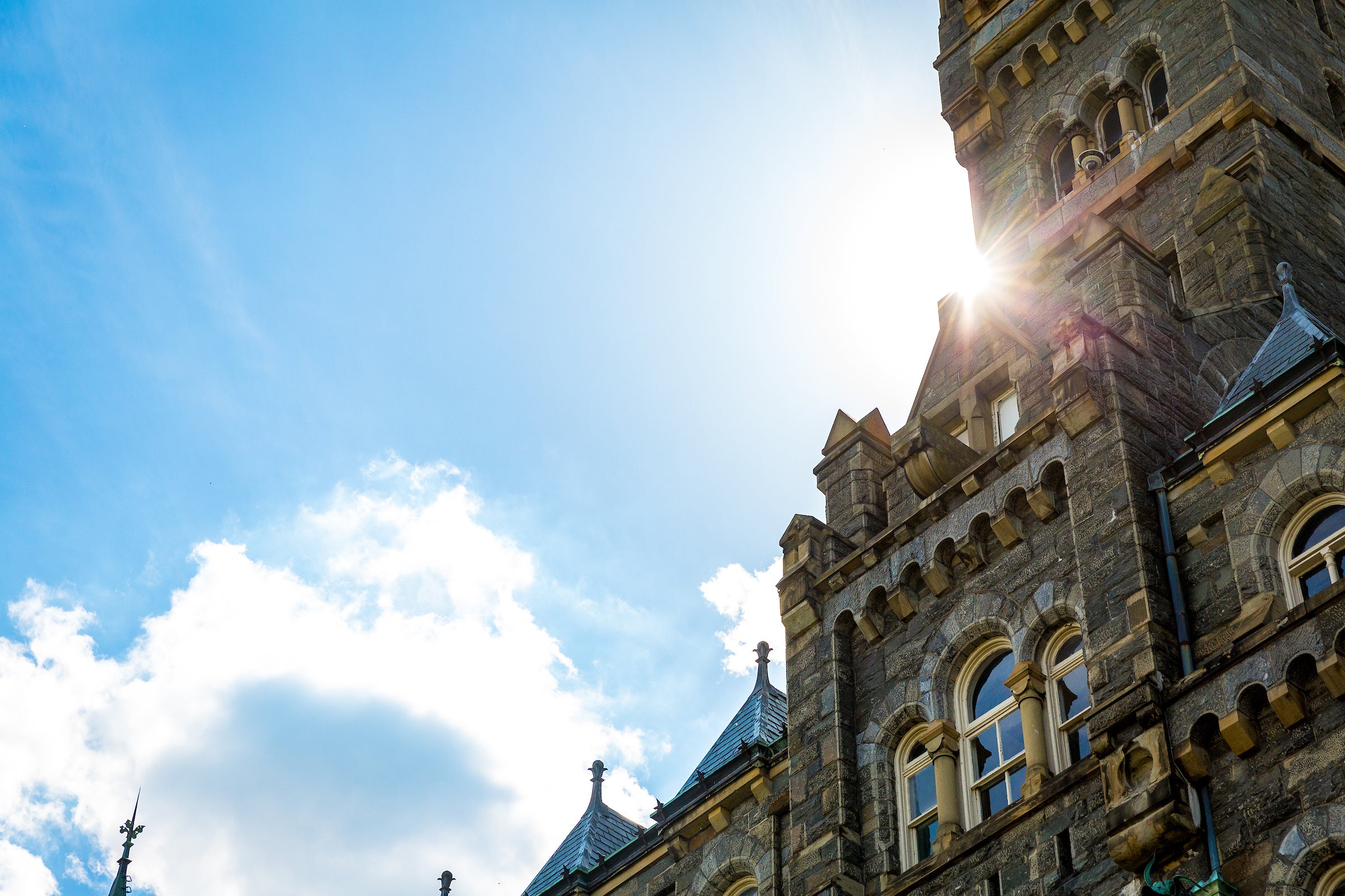 The sunny spring day in front of the Healey Building on Main Campus.