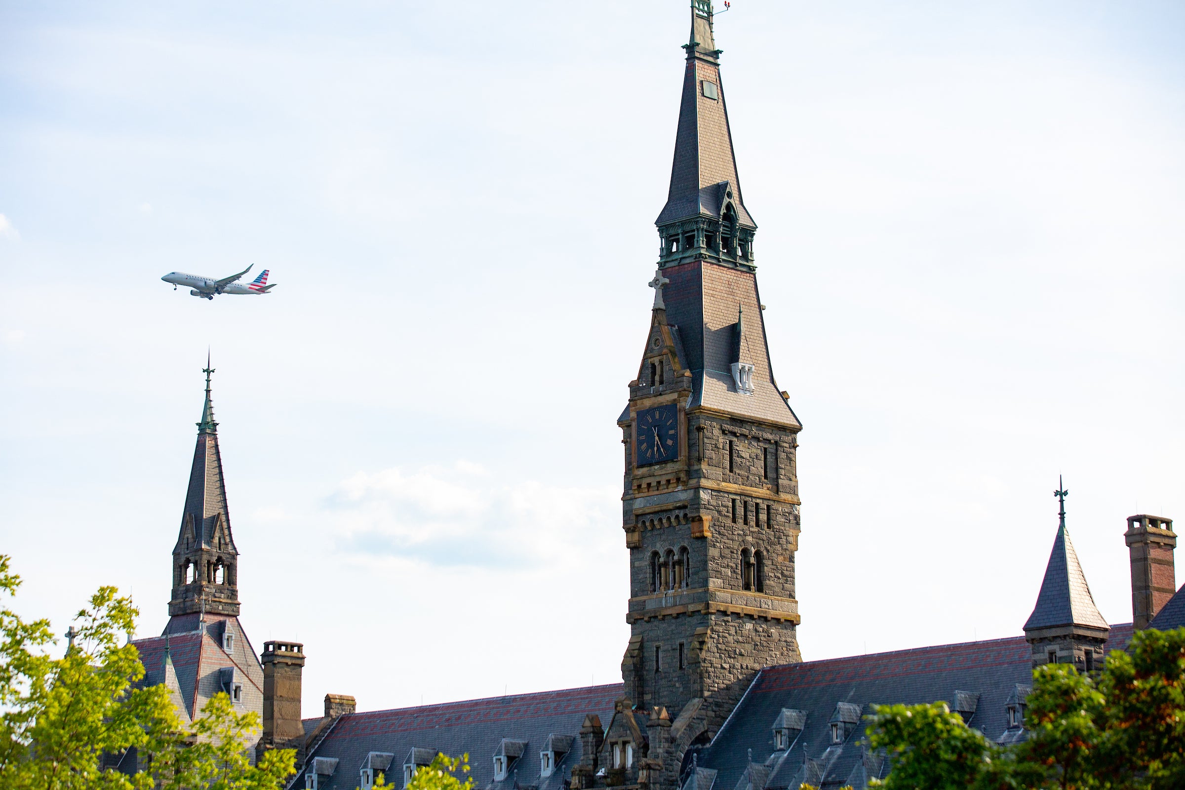 plane flying over Healy Hall